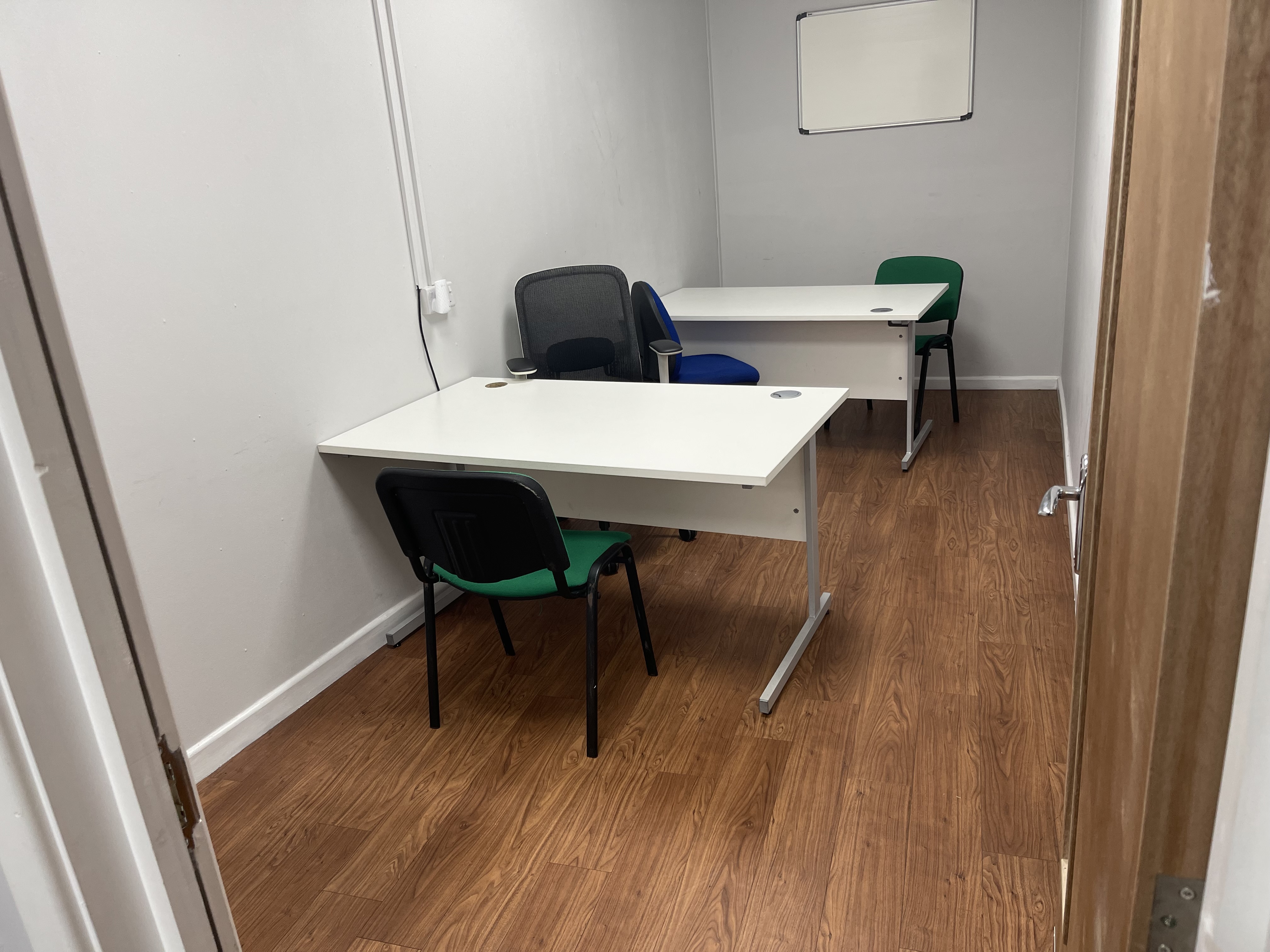 The Front Room at the Community Hub, set out with a round table and chairs