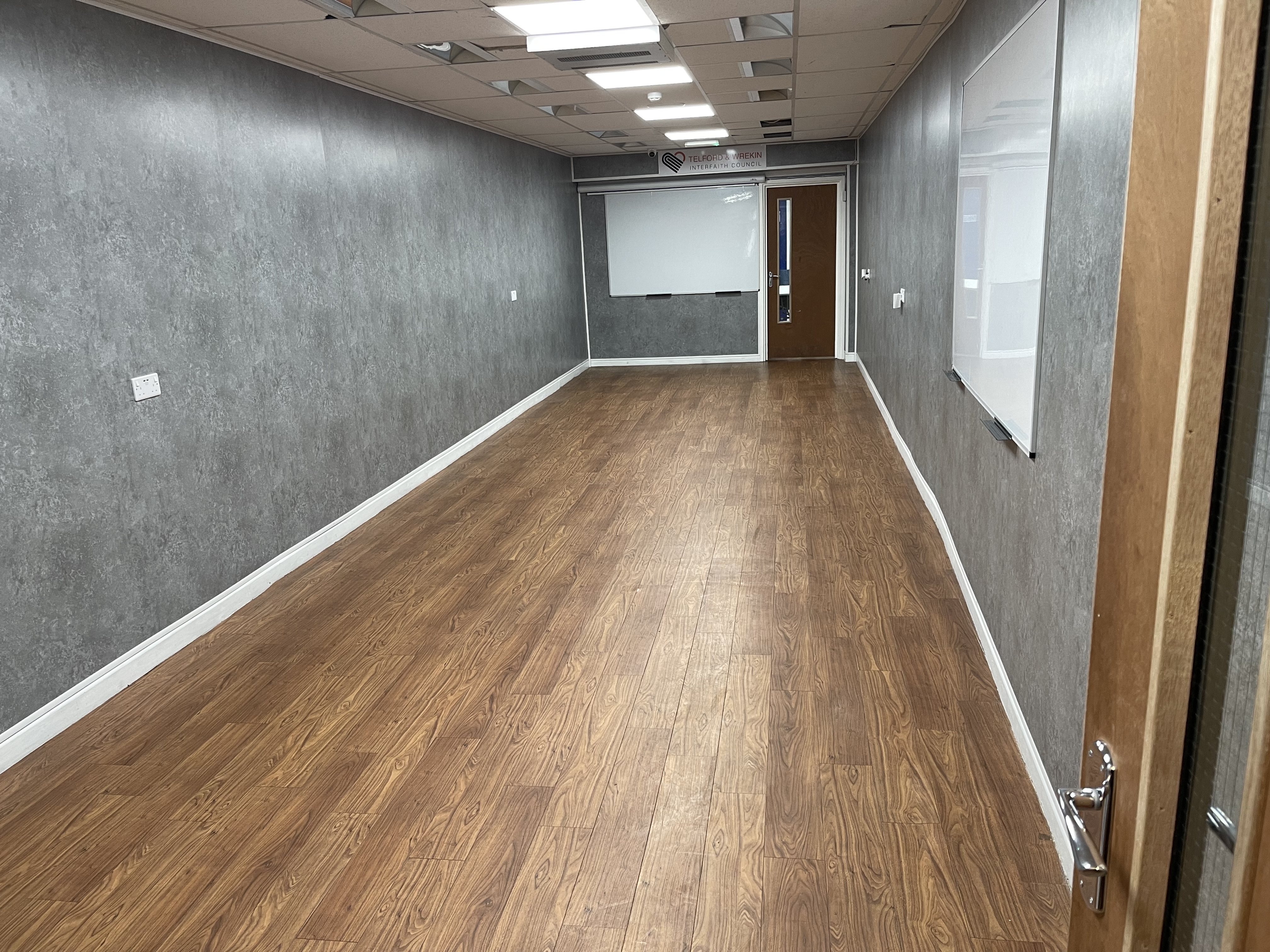 The Large Room at the Community Hub, an open room with wood-effect flooring
