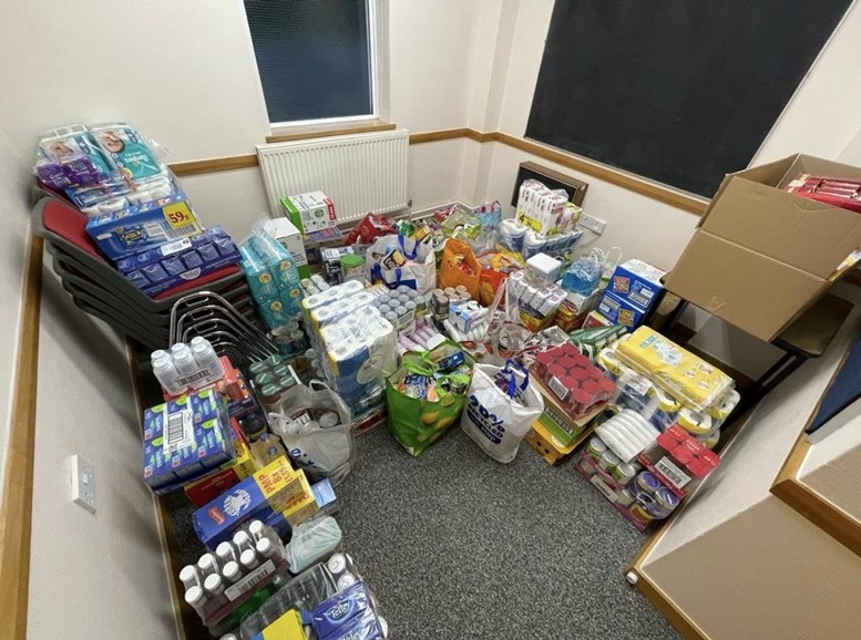 Shelves of food parcels at the Interfaith Council food store